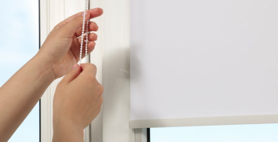 Woman,Opening,White,Roller,Blind,On,Window,Indoors,,Closeup